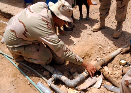 US Navy 080813-N-3560G-062 Utilitiesman 2nd Class Orlando Arromrodriguez evaluates the repairs needed on a freshwater supply plumbing fixture