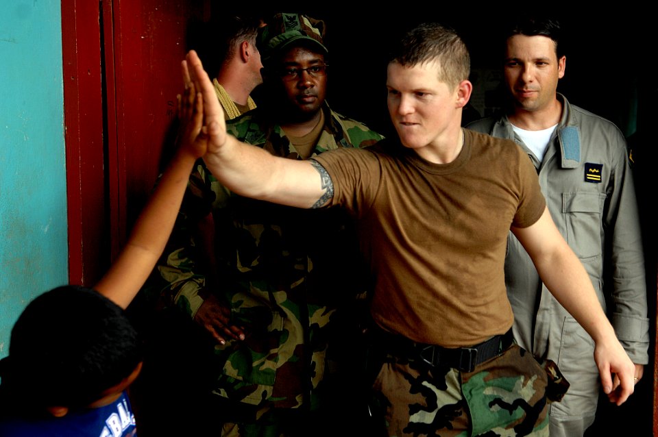 US Navy 080813-N-7544A-161 U.S. Navy Mass Communications Specialist 3rd Class Scott Parker gives a high five to a Nicaraguan child at a medical site in Puerto Cabezas during the Caribbean phase of Continuing Promise 2008