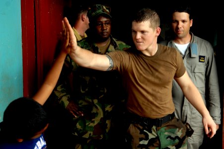 US Navy 080813-N-7544A-161 U.S. Navy Mass Communications Specialist 3rd Class Scott Parker gives a high five to a Nicaraguan child at a medical site in Puerto Cabezas during the Caribbean phase of Continuing Promise 2008
