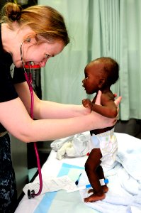 US Navy medic examining a Haitian girl after the 2010 earthquake (4295665520)