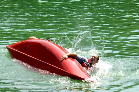 US Navy 080813-N-8467N-002 Electronics Technician 2nd Class Tim Tonsetic and his teammates from Naval Submarine School flip there canoe photo