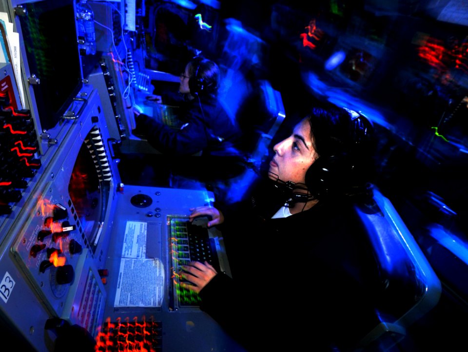 US Navy 080813-N-7981E-176 Operations Specialist Seaman Michelle Villabrille, from Pasadena, Calif., manages air contacts from a console in the display and tracking module of the Combat Direction Center aboard the aircraft carr