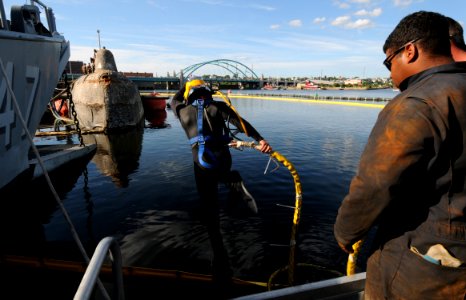 US Navy 080813-N-8933S-157 Navy Diver 1st Class Jeremy Sylvest jumps off the dive barge to remove lift bags from the former Soviet submarine-turned-museum Juliett 484