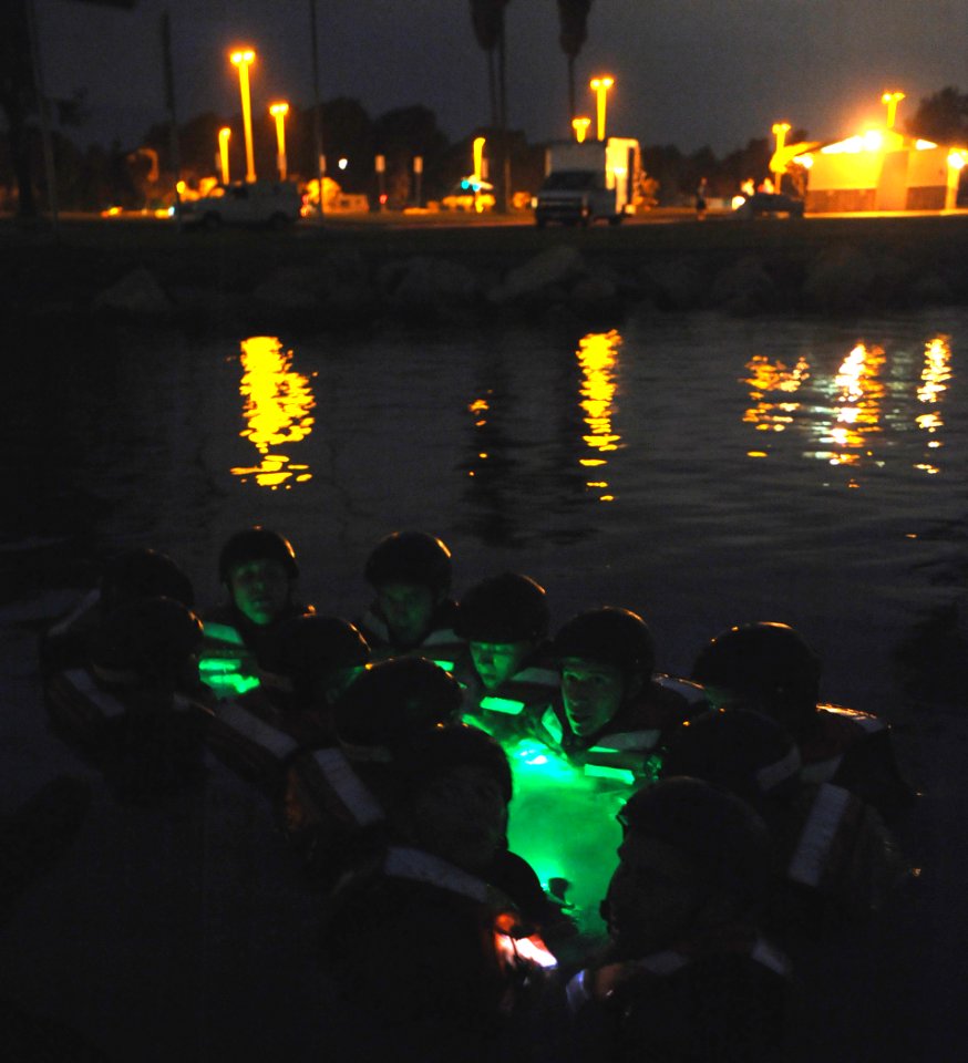 US Navy 080814-N-6552M-134 Basic Crewman Training (BCT) students huddle in a swimming circle in Mission Bay while being quizzed on navigation