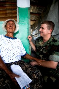 US Navy 080814-N-9620B-017 A Nicaraguan woman talks to Hospital Corpsman Mathew Coleman at Llano Verde School during a Continuing Promise 2008 medical humanitarian assistance project photo