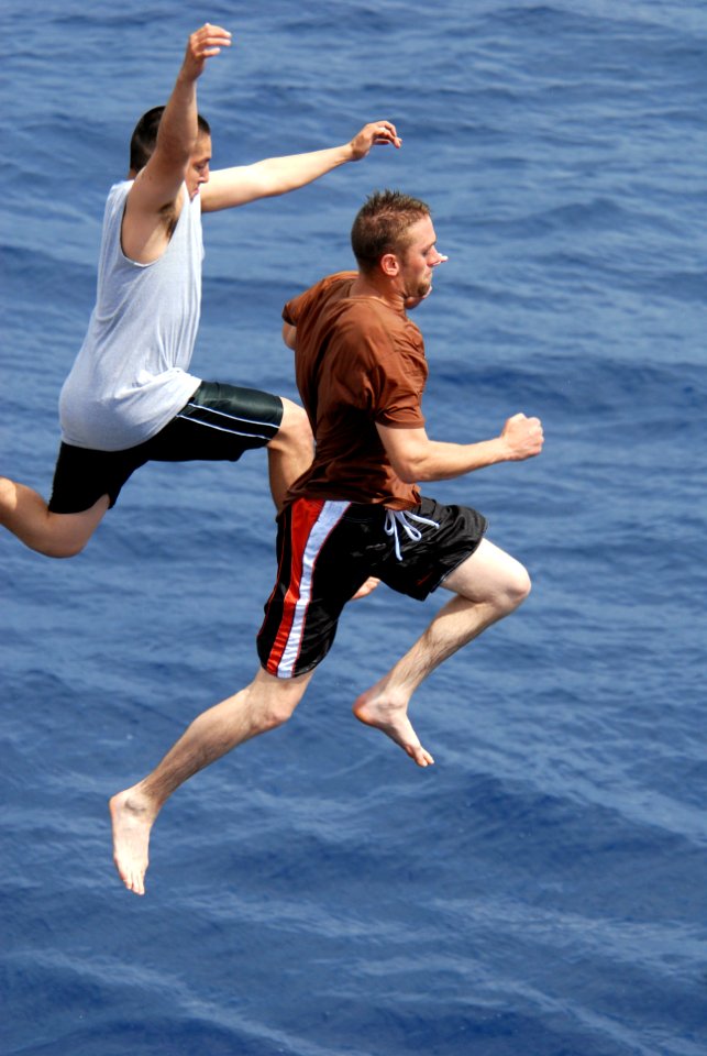 US Navy 080815-N-1635S-007 Sailors jump off of the flight deck of the Arleigh Burke-class guided-missile destroyer USS Howard (DDG 83) during a scheduled swim call