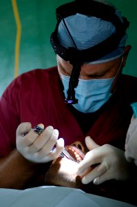 US Navy 080814-N-9620B-011 Cmdr. Michael Hill performs a tooth extraction on a Nicaraguan man at Llano Verde School during a Continuing Promise 2008 medical humanitarian assistance project