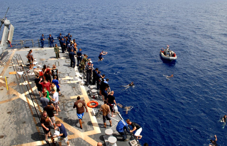 US Navy 080815-N-1635S-008 Sailors jump off of the flight deck of the Arleigh Burke-class guided-missile destroyer USS Howard (DDG 83) during a scheduled swim call