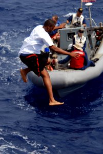 US Navy 080815-N-1635S-006 A Sailor jumps off of the flight deck of the Arleigh Burke-class guided-missile destroyer USS Howard (DDG 83) during a scheduled swim call