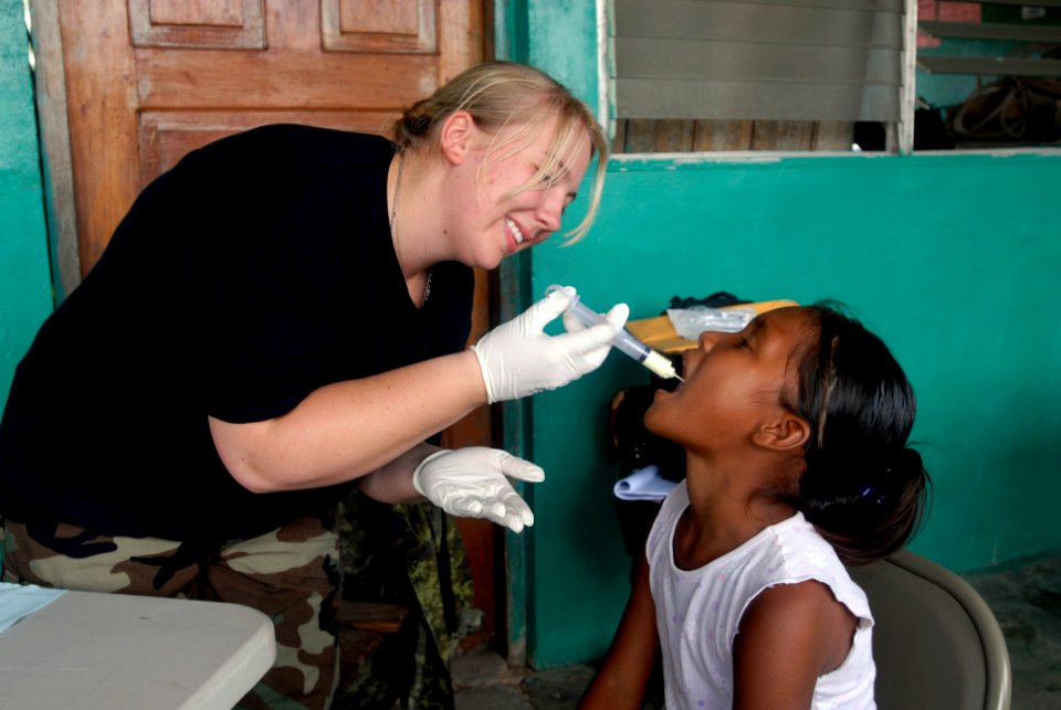 US Navy 080813-N-3595W-200 A U.S. Air Force medic gives medicine to a Nicaraguan girl during a Continuing Promise 2008 humanitarian assistance project