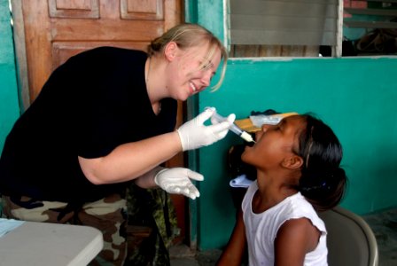 US Navy 080813-N-3595W-200 A U.S. Air Force medic gives medicine to a Nicaraguan girl during a Continuing Promise 2008 humanitarian assistance project photo