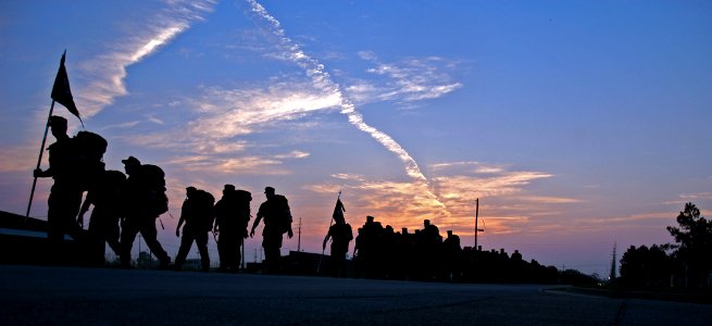 US Navy 080815-N-7367K-001 Seabees assigned to Naval Mobile Construction Battalion (NMCB) 1 carry full ruck sacks during a three-mile force march before sunrise at Naval Construction Battalion Center, Gulfport