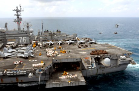 US Navy 080815-N-5961C-005 Two SH-60 Sea Hawk helicopters deliver pallets of supplies to the aircraft carrier USS Ronald Reagan (CVN 76) from the Military Sealift Command fast combat support ship USNS Bridge (T-AOE 10)