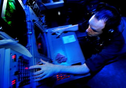 US Navy 080813-N-7981E-029 Operations Specialist 2nd Class Troy Bannister, from Coalfield, Tenn., manages air contacts while acting as an air intercept controller in the combat direction center aboard the aircraft carrier USS A photo