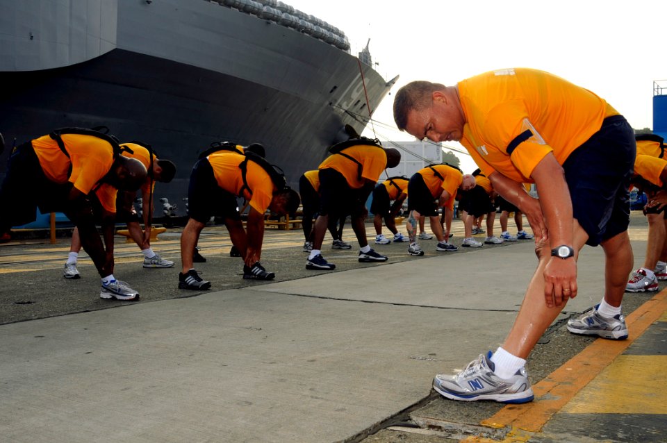 US Navy 080813-N-8546L-254 Master Chief Miguel-Juan Reyes, command master chief for the amphibious command ship USS Blue Ridge (LCC 19), leads a division of Blue Ridge and U.S. 7th Fleet staff chief selectees through stretching