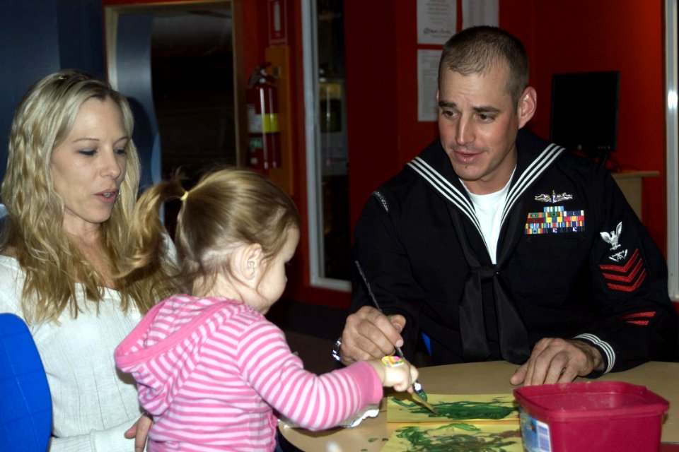 US Navy 080815-N-9123L-002 Fire Controlman 1st Class Chris Mays paints with a patient from the Royal Children's Hospital