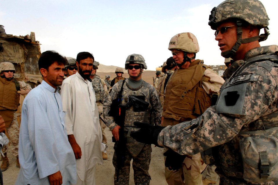 US Navy 080815-N-8273J-499 Chief of Naval Operations (CNO) Adm. Gary Roughead, speaks with Afghanistan Provincial Reconstruction Team (PRT) leaders while touring a school house construction site of PRT Ghazni