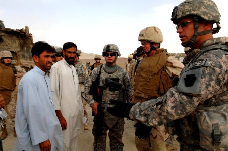 US Navy 080815-N-8273J-499 Chief of Naval Operations (CNO) Adm. Gary Roughead, speaks with Afghanistan Provincial Reconstruction Team (PRT) leaders while touring a school house construction site of PRT Ghazni