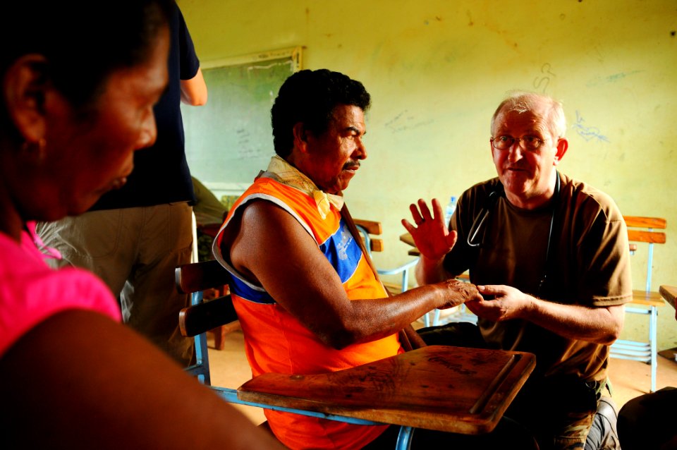 US Navy 080816-N-4515N-009 Cmdr. Killlian Dermot, a medical augmentee embarked aboard the amphibious assault ship USS Kearsarge (LHD 3), explains to the wife of a partially-paralized Nicaraguan man how she can improve her husba
