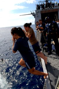 US Navy 080815-N-1635S-001 Sailors jump off of the flight deck of the Arleigh Burke-class guided-missile destroyer USS Howard (DDG 83) during a scheduled swim call