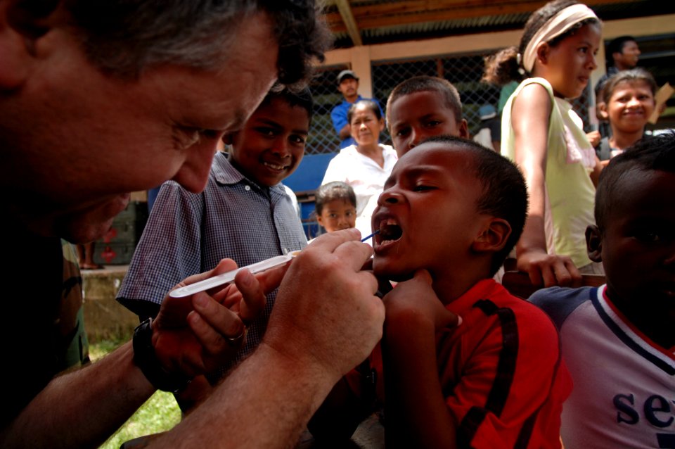 US Navy 080818-N-9620B-009 U.S. Public Health Service Lt. Cmdr. Gary Brunette cleans and applies fluoride to the teeth of a young Nicaraguan boy so the enamel of his teeth can strengthen over time