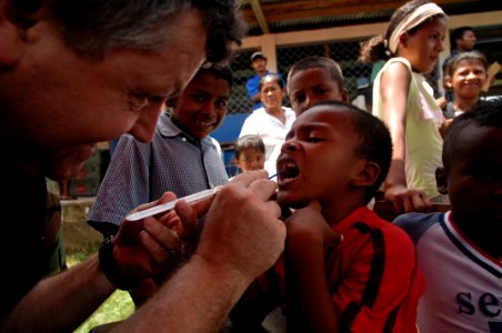 US Navy 080818-N-9620B-009 U.S. Public Health Service Lt. Cmdr. Gary Brunette cleans and applies fluoride to the teeth of a young Nicaraguan boy so the enamel of his teeth can strengthen over time