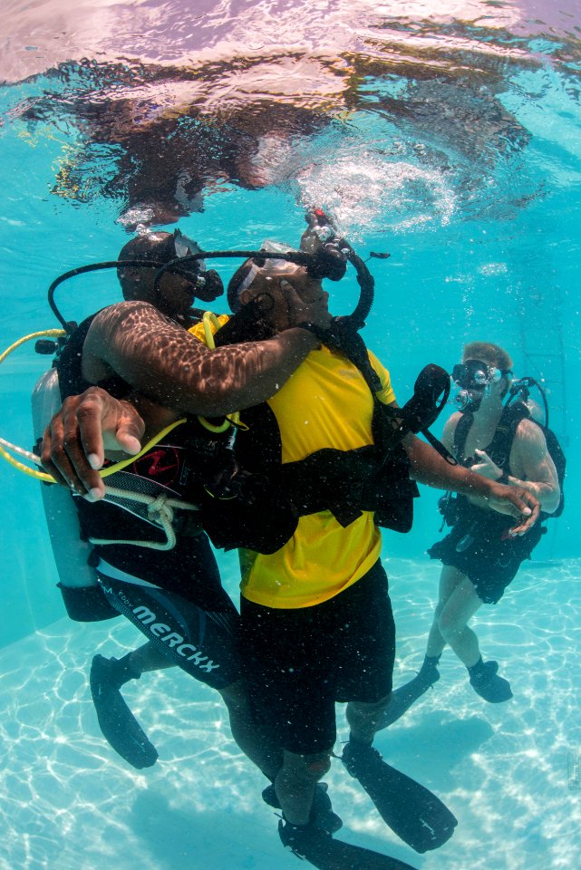 US Navy divers and Belizean coast guard divers practice SCUBA emergency procedures in a pool 140625-N-IP743-221