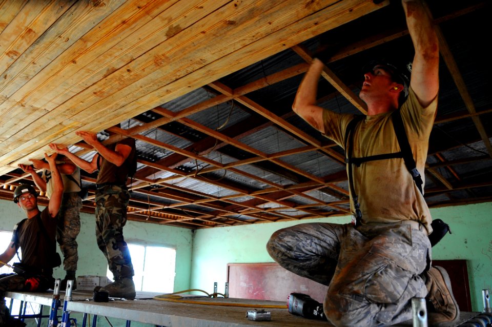 US Navy 080817-N-4515N-040 Air Force Staff Sgt. Aaron Cutaiar, a construction craftsmen assigned to the Air Force Prime Base Engineer Emergency Force embarked aboard the amphibious assault ship USS Kearsarge (LHD 3), installs t