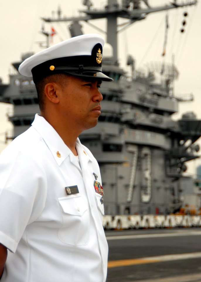 US Navy 080821-N-1038M-041 Chief Aviation Machinist's Mate Somsak Palasak mans the rails on the flight deck of the aircraft carrier USS George Washington (CVN 73)