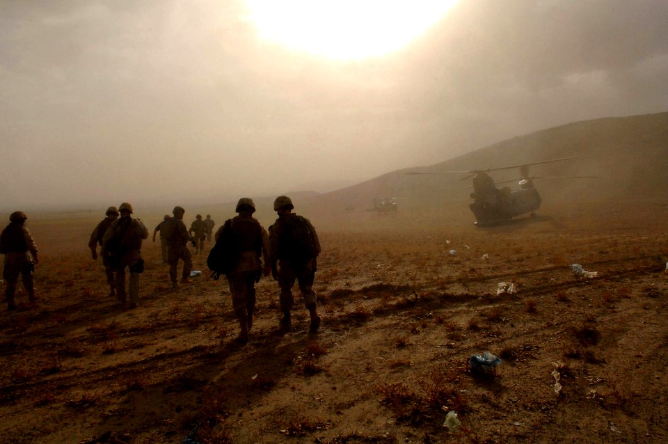US Navy 080815-N-8273J-539 Chief of Naval Operations (CNO) Adm. Gary Roughead and other military members depart a school house construction site during a visit to Provincial Reconstruction Team (PRT) Ghazni