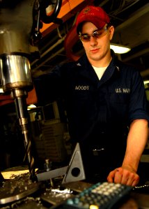 US Navy 080815-N-9079D-298 Machinery Repairman 3rd Class Tim D. Moody, from Wyalusing, Pa., drills holes to make blank flanges in the machine shop aboard the aircraft carrier USS Abraham Lincoln (CVN 72) photo