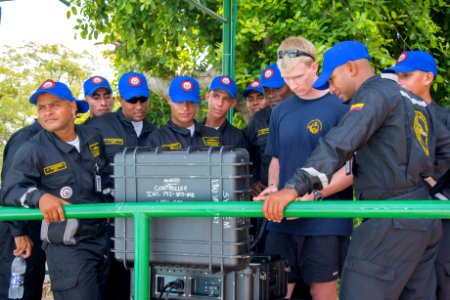 US Navy divers discuss their underwater robot with Colombian divers as part of Southern Partnership Station '14 140820-N-IP743-182