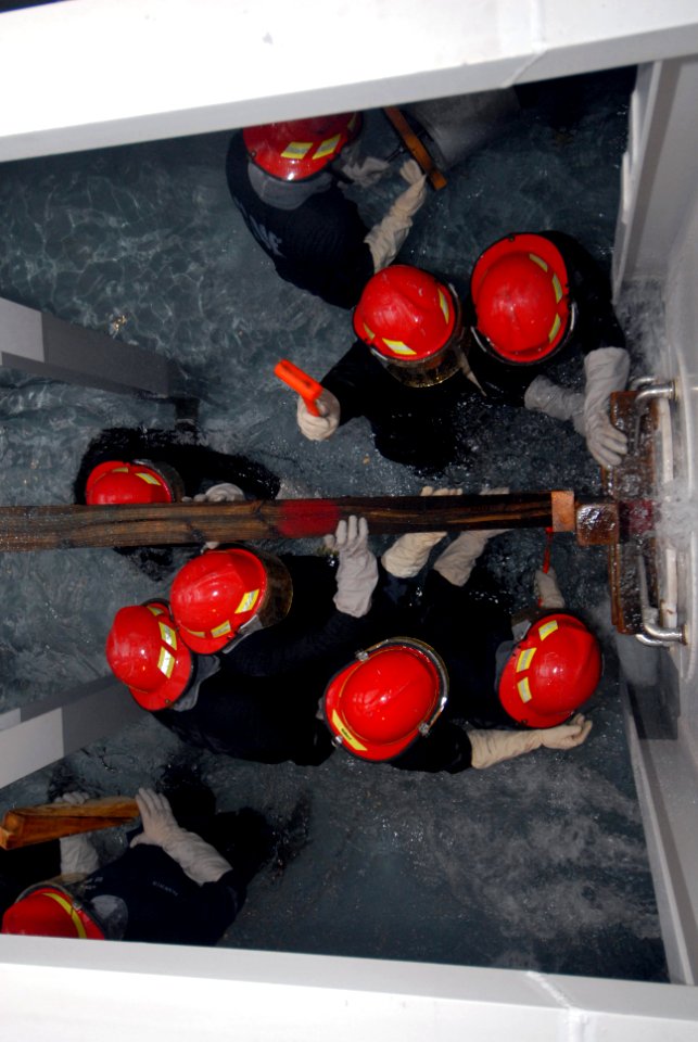 US Navy 080819-N-6936D-088 Sailors assigned to the amphibious assault ship USS Essex (LHD 2) work together to build