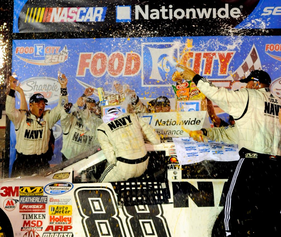 US Navy 080822-N-5345W-184 JR Motorsports team members shower driver Brad Keselowski with Gatorade and water in victory