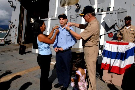 US Navy 080818-N-8273J-288 Engineman 2nd Class Jerry Valdez has 2nd class petty officer crows pinned on him by Chief of Naval Operations (CNO) Adm. Gary Roughead, right, and his wife and daughter after Valdez is promoted