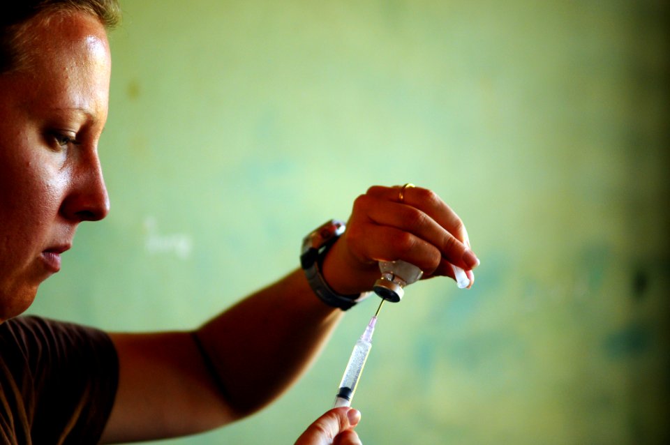 US Navy 080820-N-4515N-111 Lt. j.g. Meagan Murphy fills a syringe with a local anesthetic photo