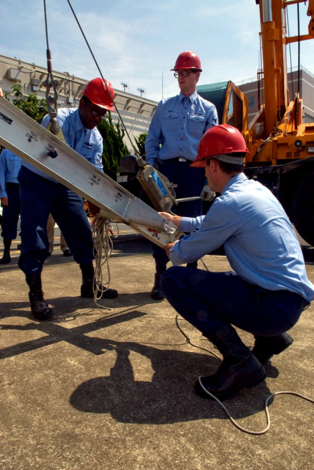 US Navy 080819-N-5253W-006 Sailors assigned to the Arleigh Burke-class guided-missile destroyer USS Curtis Wilbur (DDG 54) prepare to connect a load-bearing beam to a Harpoon missile canister