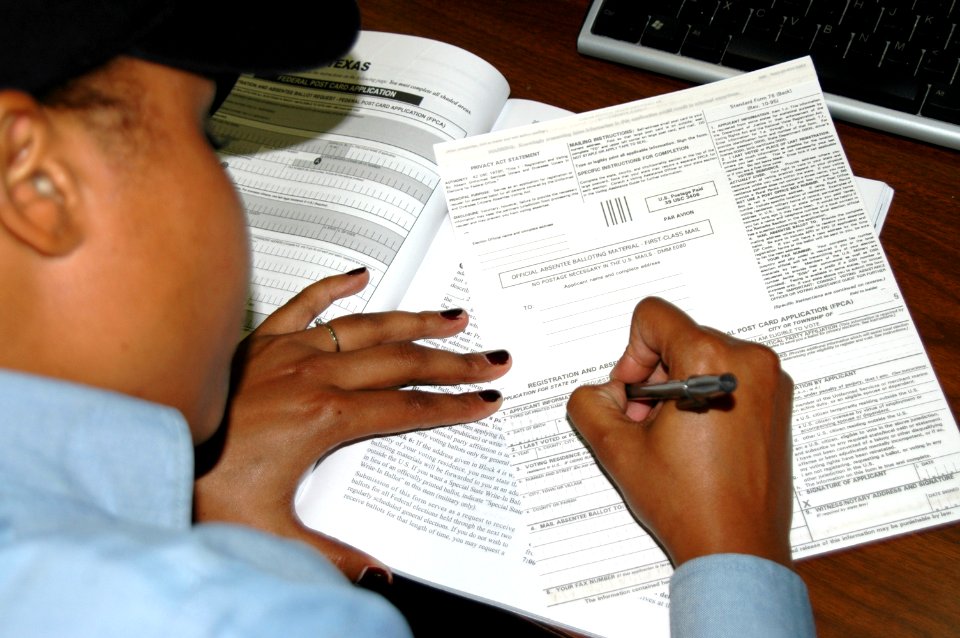 US Navy 080822-N-8154G-002 A Sailor aboard the multi-purpose amphibious assault ship USS Bataan (LHD 5) prepares her absentee ballot request to be sent to her state of residence to be eligible to vote in the upcoming election