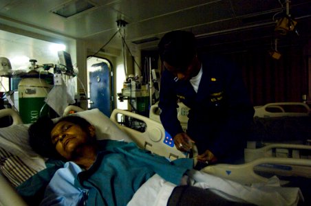 US Navy 080816-N-9620B-009 Lt. Pandora Liptrot checks the vitals of Amalia Urbina Tilleth, a native of the Miskito tribe of Nicaragua, shortly after a surgical procedure aboard the amphibious assault ship USS Kearsarge (LHD 3) photo