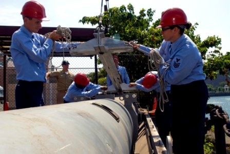 US Navy 080819-N-5253W-007 Sailors assigned to the Arleigh Burke-class guided-missile destroyer USS Curtis Wilbur (DDG 54) prepare to connect a load-bearing beam to a Harpoon missile canister