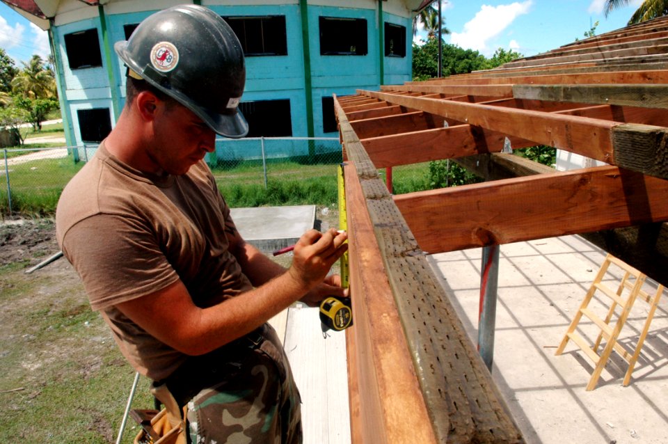 US Navy 080823-N-1328S-002 Constructionman Steven Cline, assigned to Navy Mobile Construction Battalion (NMCB) 133, makes adjustments for the reconstruction of Mwan Elementary School during a Pacific Partnership engineering civ