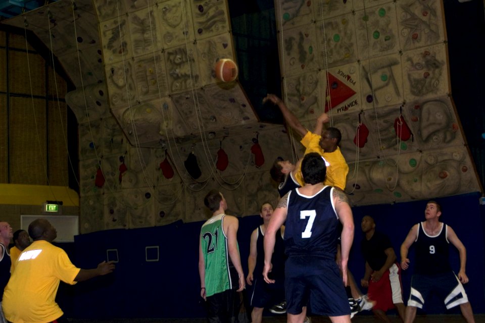 US Navy 080822-N-9123L-002 Culinary Specialist 3rd Class Jim Rahmaan, from Fayetteville, N.C., tips-off the start of a basketball game with the Royal Australian Navy during the guided-missile destroyer USS John S. McCain's (DDG