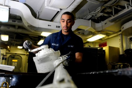 US Navy 120130-N-RG587-537 A Sailor reels in the load cable of a bomb hoist