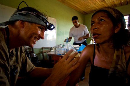 US Navy 080820-N-9620B-009 Lt. Cmdr. Nathan Upbelhoer examines an abnormal irritation on a local Nicaraguan woman photo