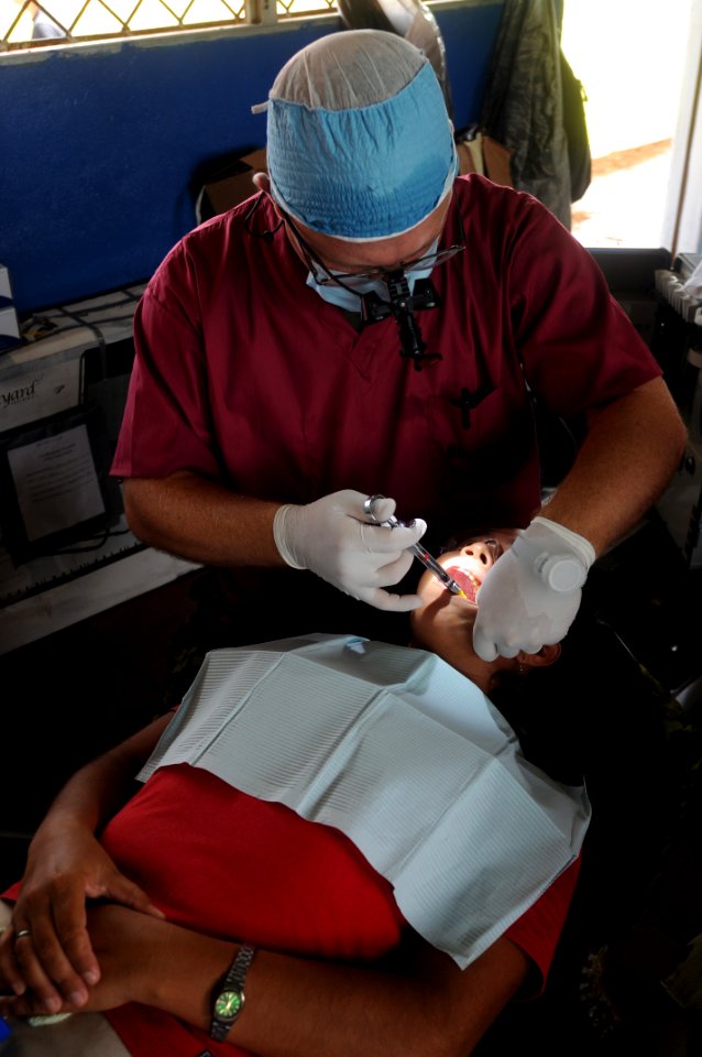 US Navy 080817-N-7955L-031 Capt. Ian Thorton, a Canadian dentist embarked aboard the amphibious assault ship USS Kearsarge (LHD 3), conducts a dental procedure at the Betania medical clinic photo