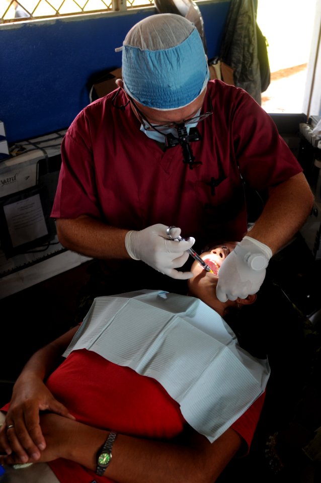 US Navy 080817-N-7955L-031 Capt. Ian Thorton, a Canadian dentist embarked aboard the amphibious assault ship USS Kearsarge (LHD 3), conducts a dental procedure at the Betania medical clinic