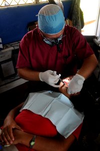 US Navy 080817-N-7955L-031 Capt. Ian Thorton, a Canadian dentist embarked aboard the amphibious assault ship USS Kearsarge (LHD 3), conducts a dental procedure at the Betania medical clinic photo