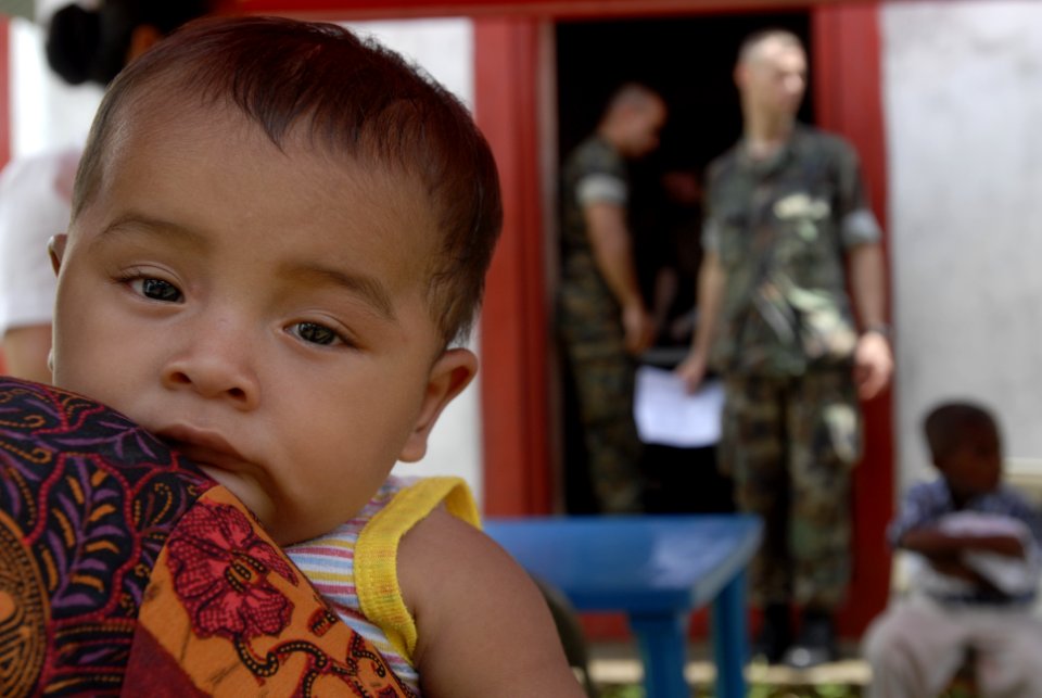 US Navy 080821-N-3595W-046 A baby leans on his mother while waiting for a pharmaceutical technician