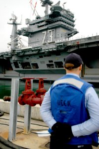 US Navy 080821-N-7029R-028 A Sailor assigned to the aircraft carrier USS Kitty Hawk (CV 63) stands at parade rest as the aircraft carrier USS George Washington (CVN 73) departs Naval Air Station North Island