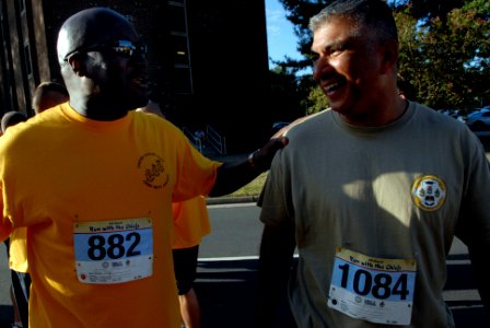 US Navy 080823-N-9818V-314 Master Chief Petty Officer of the Navy (MCPON) Joe R. Campa Jr. speaks with Force Master Chief Frederick Pharr, Naval Air Force, U.S. Atlantic Fleet, as they make their way to the start line of the fo